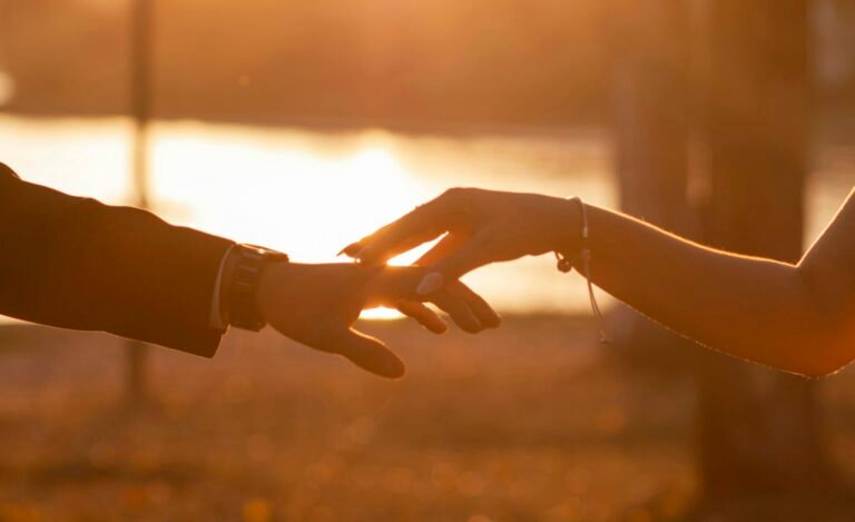 Couple holding hands at sunset